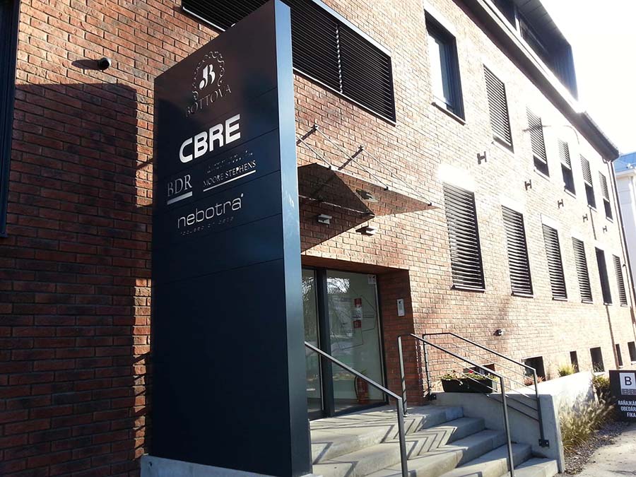 Sklenená markíza a informačný totem v industriálnom štýle pozdvihujúci dizajn budovy | DOMO GLASS